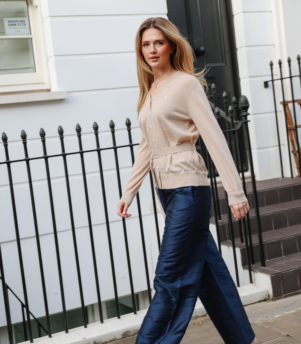 Full-length view of the Margot Knit Cardigan in Sandstone, featuring a relaxed fit, ribbed cuffs, and a soft neutral beige tone.