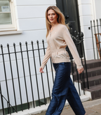 Full-length view of the Margot Knit Cardigan in Sandstone, featuring a relaxed fit, ribbed cuffs, and a soft neutral beige tone.
