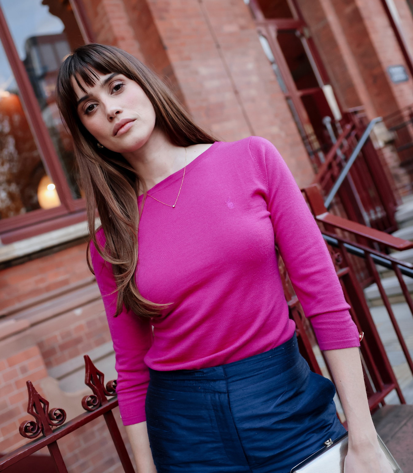 Close-up of the Sloane Knit Top in Magenta showing its intricate braid and diamond texture, short sleeves, and ribbed neckline.